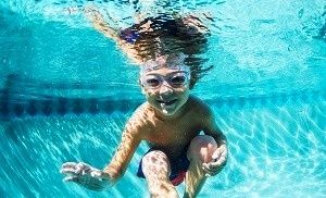 little boy swimming underwater 