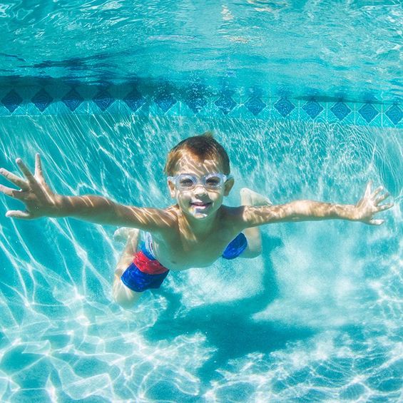 little boy swimming 